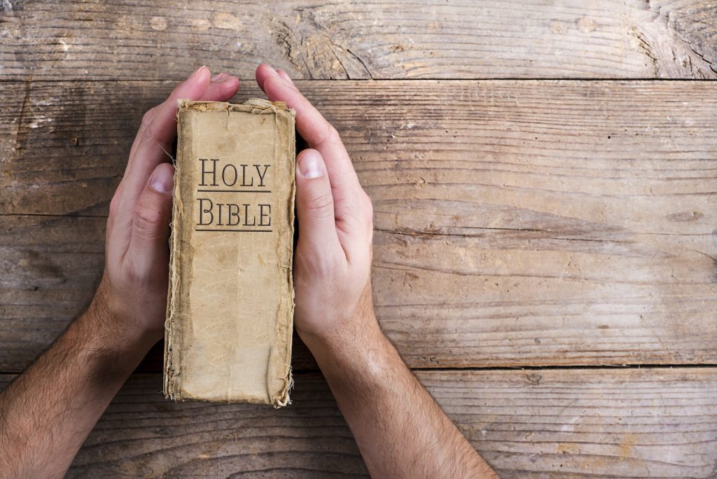 Bible and praying hands